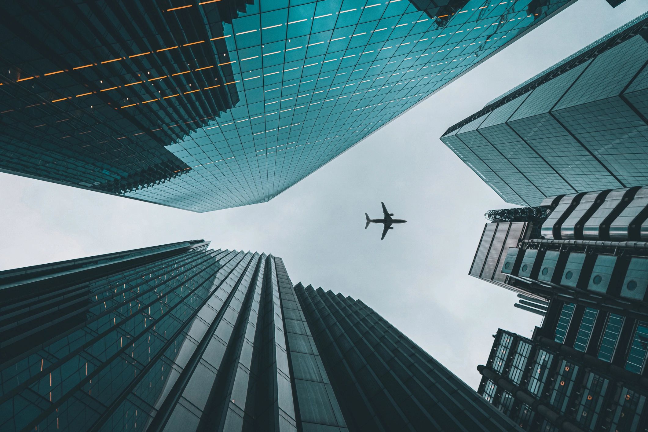 A traveler stands on a mountain ridge, arms open, embracing the spirit of discovery.